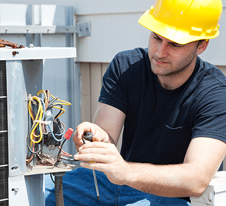 Image of an engineer engaged in air conditioner repair